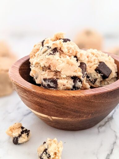 Small wooden bowl filled with cookie dough balls.