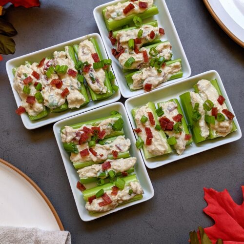 4 small plates of stuffed celery bites.