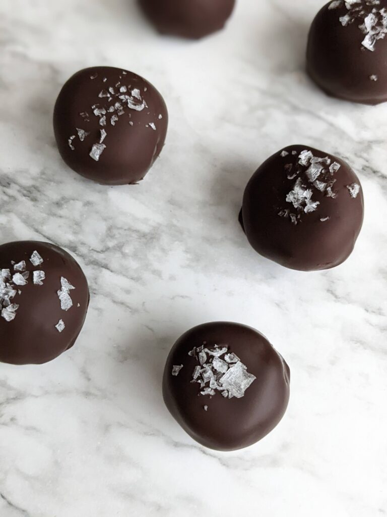 4.5 bon bons sitting on white marble, evenly spaced about an inch apart.