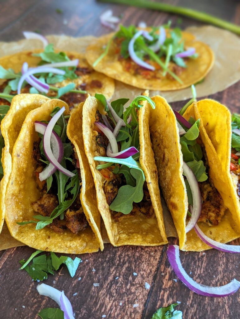 Closeup of the tacos lined up in a row.
